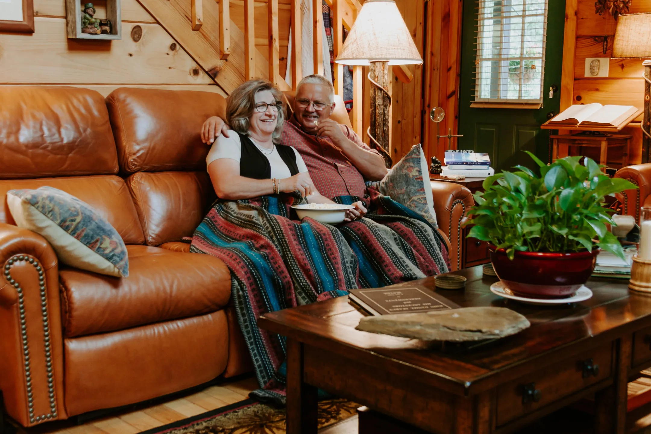 Couple Sitting on Leather Reclining Couch