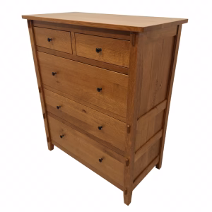 A light-colored wooden dresser with six drawers and black knobs stands against a white background, showcasing its clean, minimalist design.