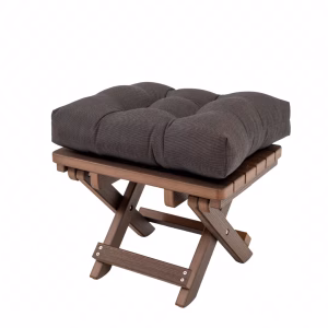 A wooden folding stool with a dark gray cushioned seat and four legs is positioned against a white background.