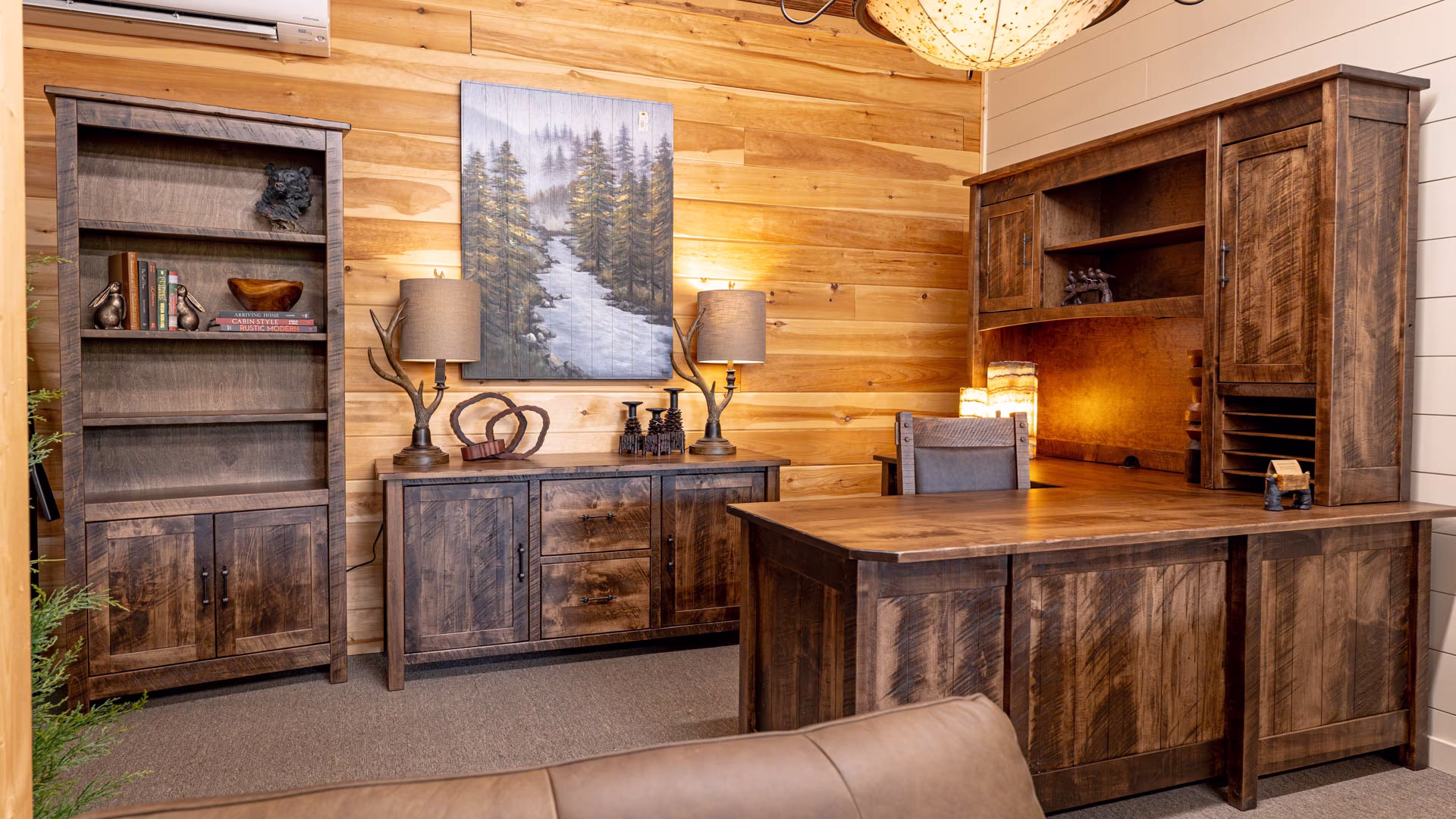 A warm and inviting home office features a wooden desk, bookshelf, and dresser, adorned with books, plants, and decorative objects, and a large window offers a view of the outdoors.