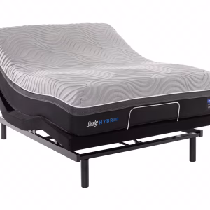 A black and gray Sealy Hybrid mattress, adjusted to an angle with metal legs, features a blue logo and a white cover with a wave-like pattern against a white background.