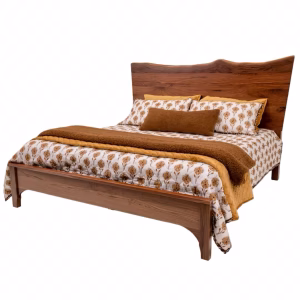 A wooden bed with a headboard and footboard features a floral comforter and brown pillows, set against a white background.