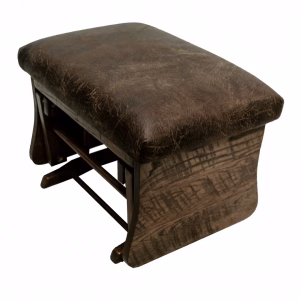 A dark wooden ottoman with a curved backrest and footrest, upholstered in brown leather with a distressed texture, stands against a white background.