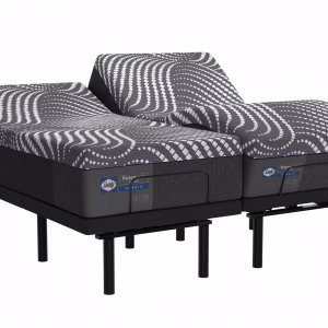 Two gray and white striped Sealy Posturepedic mattresses, adjustable and labeled "Hybrid," are stacked on a black metal frame against a white background.