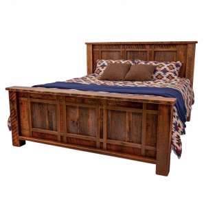 A wooden bed with a headboard and footboard, dressed in a blue and brown patterned comforter and pillows, stands against a white background.