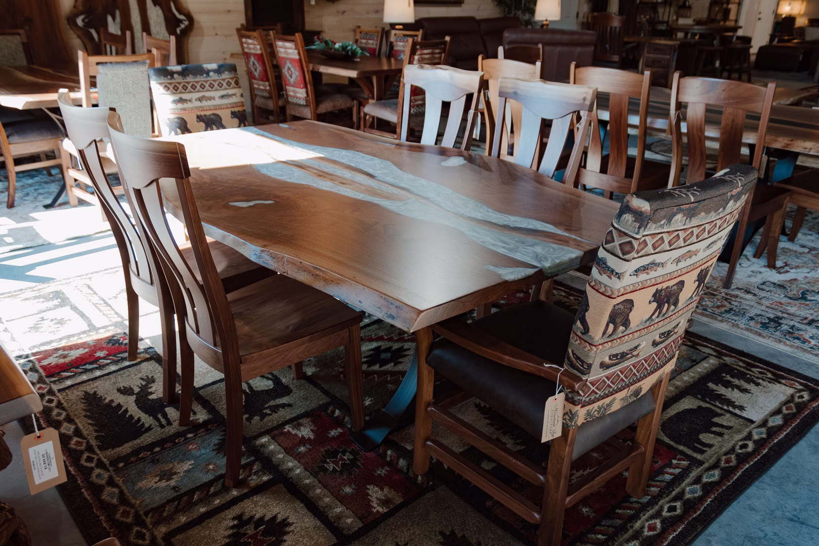 A wooden table with a white marble top and a bench seat with a colorful fabric cover are situated in a furniture store, surrounded by wooden chairs and tables.