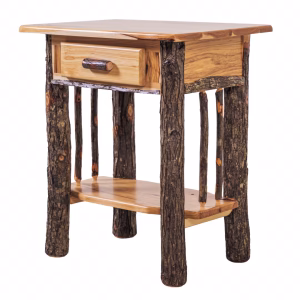 A wooden nightstand with a single drawer and a shelf holds a lamp and set against a white background.