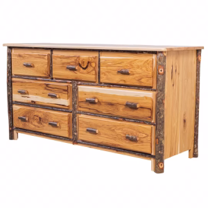A light-colored wooden dresser with six drawers and dark brown branch accents stands against a white background, showcasing its rustic charm.