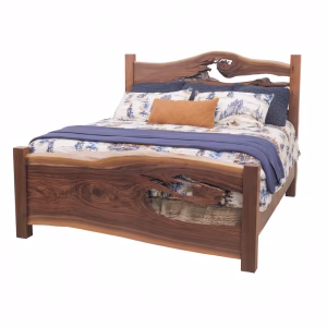 A dark wooden bed with a curved headboard and footboard features a blue and white floral comforter, orange and gray pillows, and a woven throw blanket.