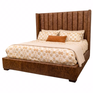 A brown leather bed with a high headboard and footboard, featuring a white and gold patterned comforter, is accompanied by two orange throw pillows against a white background.