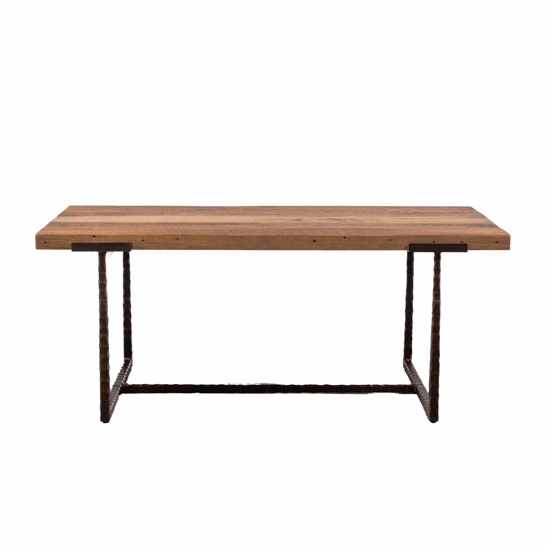 A rectangular industrial-style table featuring a thick, light-brown wooden top and a black metal frame base.