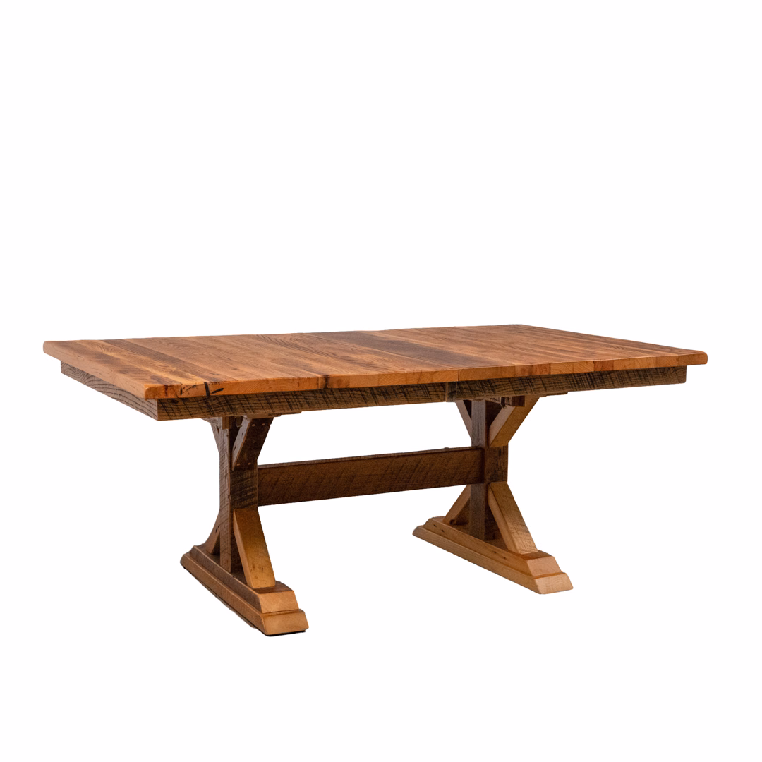 A rustic brown wooden trestle table with X-shaped legs and a rectangular top, set against a plain white background.