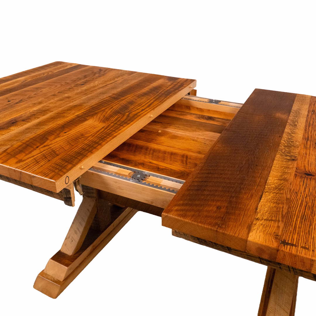 A rustic, reddish-brown wooden table with a sliding tabletop that expands to reveal a hidden section.