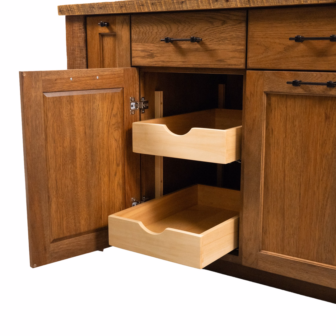 A honey-colored wooden kitchen cabinet with one door open to reveal two internal pull-out drawers.